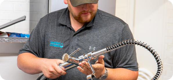 Mastery Plumbing technician working on water filtration system